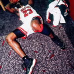 Michael Jordan on the floor celebrating an NBA championship with the Chicago Bulls