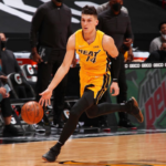 Tyler Herro dribbling in the Miami Heat trophy gold collection jersey