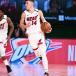 Tyler Herro dribbling in the white Miami Heat jersey 